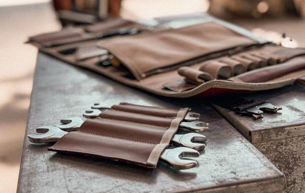 Open tool roll with wrenches on a workbench